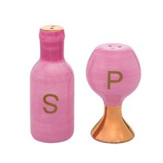 two pink salt and pepper shakers with the letters p on them, one in gold