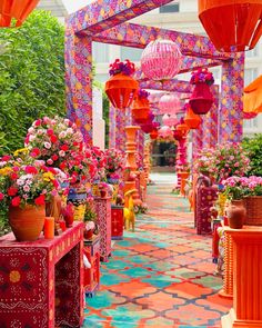 the walkway is decorated with colorful lanterns and potted plants