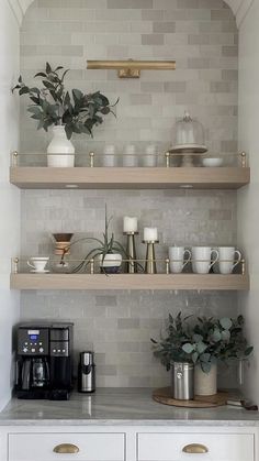 the shelves in this kitchen are filled with cups and saucers, plants, and coffee maker