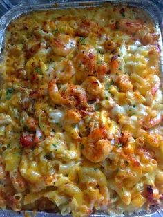 a casserole dish with shrimp and cheese in it