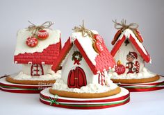 three gingerbread houses decorated with icing and candy canes on top of each other