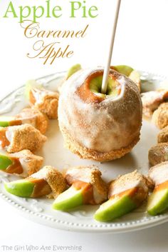 an apple pie covered in icing sitting on top of a white plate