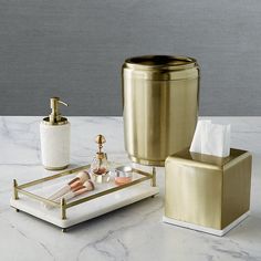 gold bathroom accessories set on marble counter top