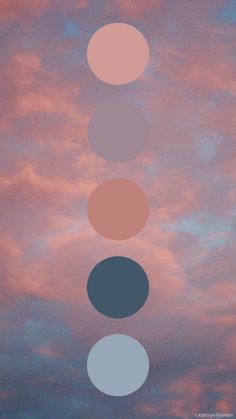 the sky is pink and blue with three different circles on it, as well as some clouds