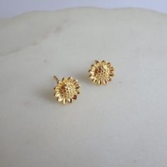 Description: *  925 sterling silver - all components, *  24 k gold plated - all components, *  size 8 mm diameter, *  sunflower studs come with sterling silver gold plated backs, *  high quality, *  earrings will be sent in a jewellery gift box. You can visit my shop for more designs, please click: https://meloujewellery.etsy.com Free shipping will be provided to the UK customers. Please note, no tracking number will be available with that method. On average it takes 2 to 3 working days to be de Yellow Gold Plated Flower Earrings For Anniversary, 14k Gold Flower Earrings For Gift, Dainty Gold Flower Earrings For Anniversary, Gift Gold Flower Earrings Tarnish Resistant, Handmade Yellow Gold Flower Shaped Earrings, Flower Shaped Yellow Gold-plated Earrings, Gold Flower Earrings In 14k Round Shape, Gold Round Flower Earrings In 14k Gold, Gold Plated Yellow Gold Flower Earrings