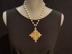 "❤️❤️  20% off and Free Shipping ❤️❤️ Ethiopian Gold Coptic Cross Rosary Chain Choker Necklace with white Howlite beads Made to order from 16\" to 36\" length 8 Cross designs to chose from. Please refer to pictures and order by number.  Crosses are gold toned brass and measure approximately 3\".  8mm white Howlite beads in your choice of length.  - packaged in a complimentary brocade silk jewelry bag for gifting - Free shipping The cross is the ultimate symbol of spiritual faith, devotion and love. Crosses are seen to ward off evil and bring spiritual protection, healing and hope.  These unique and one of a kind brass Coptic Crosses are handmade by the Christian community of Ethiopia. They have a gold patina over brass with a lovely etched design  Coptic crosses express Faith, Devotion and Gothic Cross Necklace, Coptic Cross, Spiritual Faith, Cross Rosary, Gothic Cross, Silk Jewelry, Gothic Crosses, Spiritual Protection, Rosary Chain