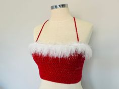 a mannequin wearing a red and white dress with feathers on it's chest