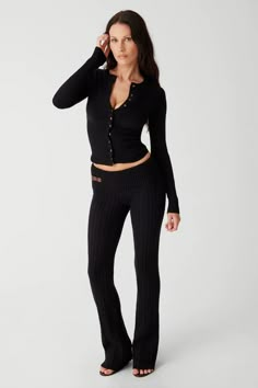 The updated Fleur pant in Black is sweet from every angle, with a low-rise fit, a ribbed rollover waist, and vintage-inspired hardware + trim. Fleur also features our coziest cable cloud knit fabric and flared legs. The Fleur pant is designed to flatter in every size and to be cherished for seasons to come. 50% Viscose + 27% Polyamide + 23% Polyester Cable Cloud Knit Fabric This style runs true to size Soap is wearing a size Small Height 5' 5” (166.5cm) Bust 29” (73.66cm), Waist 22.5" (57.15cm), Womens Skirt Suits, Black Knit Sweater, Frankies Bikinis, Knit Hoodie, Swimwear Outfit, Knit Pants, Black Knit, Black Cardigan, Fashion Inspo Outfits