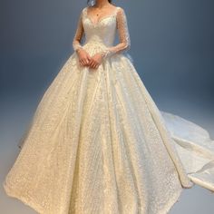 a woman in a white wedding dress is posing for the camera with her hands on her hips