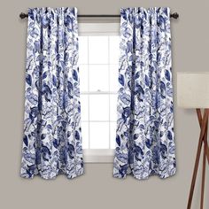 the blue and white curtains are hanging in front of a window