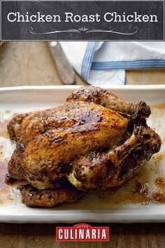 a roasted chicken sitting on top of a white plate