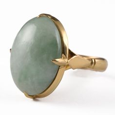 Stunning vintage Chinese estate ring with an eye-catching light green jadeite jade cabochon set in solid 18k yellow gold. This elegant ring is sure to make a statement with its large 21mm x 16mm oval jade cabochon. Best fits a size 7.75 finger, the interior is signed with an unknown Chinese hallmark. The band measures 4mm in width by 1mm in depth, the centerpiece is approximately 9mm in depth. This gorgeous ring has been tested for gold & stone purity using an electronic gold tester along with a gemstone tester. Free shipping within the continental U.S.A., signature is required upon delivery. ♥ Please full-view each photo for detail / wear and ask any questions prior to purchasing ♥ Colors may vary from monitor to monitor. Mannequins are smaller than a standard adult hand & bust. ♥ As alwa Yellow Gold Jade Cabochon Ring, Oval Jade Rings In Yellow Gold, Yellow Gold Jade Ring With Gemstone, Elegant Oval Chrysoprase Rings, Yellow Gold Jade Jewelry With Cabochon, Polished Chrysoprase Ring Jewelry, Elegant Green Domed Jewelry, Polished Yellow Gold Jade Jewelry, Classic Polished Jade Jewelry