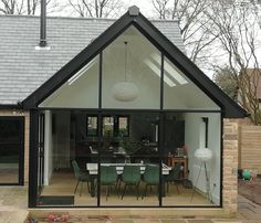 a dining room and kitchen area are separated by an extension to the outside of the house