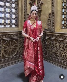 a woman in a red and gold outfit posing for the camera