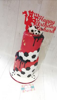 a red and black birthday cake on a white table