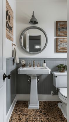 a white sink sitting under a mirror in a bathroom next to a toilet and bathtub