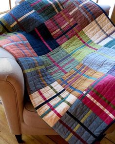 a couch with a colorful quilt on it