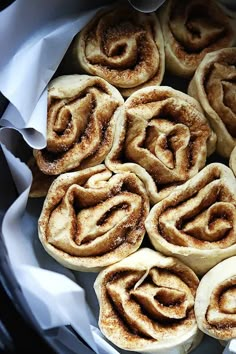 some cinnamon rolls are sitting in a pan