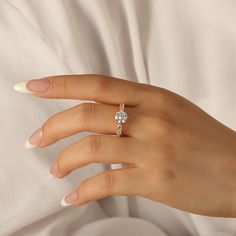 a woman's hand with a diamond ring on it