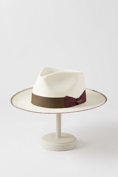 Light and airy, our Monty shantung straw fedora is crafted in the United States to help you keep your cool under the scorching sun. Monty is fully equipped to shield you from intense rays, and its generous brim with whipstitch accents, grosgrain ribbon and bow hatband, and impressive teardrop crown uphold the longstanding tradition of fine hat making.