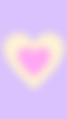 a blurry image of a pink heart on a purple and yellow background with white highlights