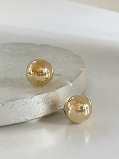 Ball Post Earrings  D E T A I L S - 18K Gold Filled Earrings - Size Diameter 14mm - Sold as a pair - Lightweight with a hollow inside - Push Back Closure P A C K A G I N G Dylan Rae Jewelry is elegantly presented in our premium microfiber jewelry case, ensuring both protection and a polished presentation. If you require separate packaging for multiple items, kindly let us know. C A R E Care for Your Gold Filled Jewelry: Wear It, Love It, Care for It! Our gold-filled pieces are crafted to be your lifelong companions. Feel free to wear them every day, even while showering, but remember to avoid exposing them to saltwater and chlorine. These elements can diminish their luster over time and may even cause oxidation if they come in contact with your jewelry. Additionally, it's best to remove yo Gold Hypoallergenic Round Bead Earrings, Gold Hypoallergenic Earrings With Round Beads, Gold Hypoallergenic Earrings, Gold Earrings With Round Beads For Pierced Ears, Gold Round Beads Earrings For Everyday, Everyday Gold Round Bead Earrings, Everyday Gold Round Beaded Earrings, Classic Gold Earrings With Round Beads, Ball Earrings Gold