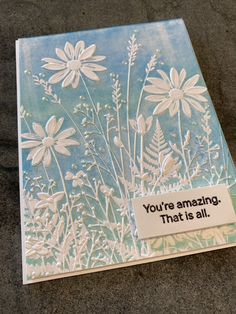 a card with some flowers on it that reads you're amazing, that is all