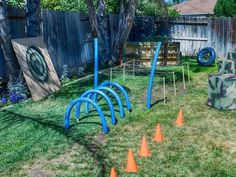 an outdoor game set up in the backyard with cones and tees on the grass