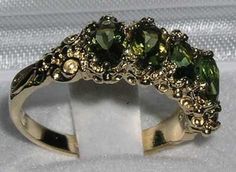 Five Stunning Green Tourmalines set within this delightful English Victorian style Gold setting. Each Tourmaline measures approx 6x4mm (0.24"x0.16"), is securely claw set, and the setting has a nice solid feel with a substantial shank.Completely made from Solid English Yellow 10K Gold, tested and Hallmarked by the Assay Office which confirms the purity of the Gold. The Hallmark includes the .417 marking plus the unique mark of the Assay Office.These are Genuine Natural Tourmalines. They have a D Trilogy Ring, Gold Ring Sets, Peridot Ring, Green Peridot, Dream Jewelry, Pretty Jewellery, Gold Gold, Antique Style, Vintage Stil