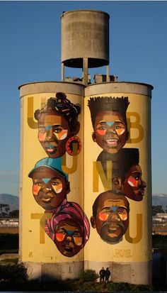 a large water tower with several faces on it