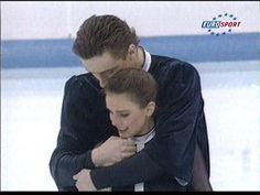 two people hugging each other on an ice rink