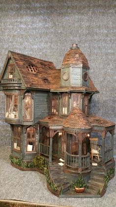 a wooden doll house with porch and stairs