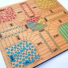 a wooden board game with different colors and patterns on it, including the name's