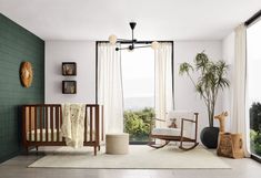 a baby's room with a rocking chair, crib, and large window