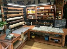 a workbench with lots of crafting supplies and tools on it's shelves