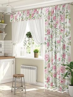 a white kitchen with pink roses on the curtains