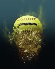 a yellow ball floating in the water with its reflection on it's back side