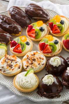 an assortment of desserts are arranged on a platter