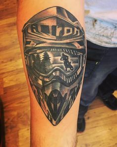 a man's arm with a star wars themed tattoo on it, and an image of a helmet