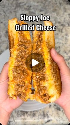 a person holding up a sandwich with the words sloppy joe grilled cheese on it