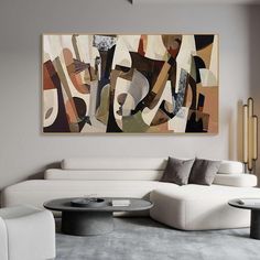 an abstract painting hangs above a white couch