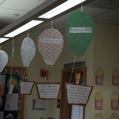 some paper hot air balloons hanging from the ceiling