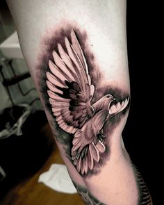 a black and white bird tattoo on the leg