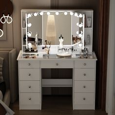 a white vanity with lighted mirror and drawers