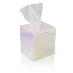 a tissue dispenser sitting on top of a white surface