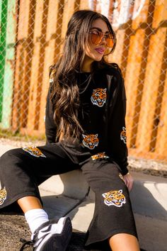 Lala Original Designs are thoughtfully designed in-house. These clothes were made for you. SWEATER:- Tiger heads all over- Black background color- Relaxed, boxy fit with a cropped silhouette- Weighty, stretchy knit material- Ultra soft fabric- Wide neck (similar to boatneck) PANTS:- Tigers on a black background- Wide leg silhouette- Cropped culotte style- High-waisted fit- Thick stretchy waistband- Knit has a lot of stretch Lex is 5'8", typically wears a size 4/6 and wearing a Medium. Symone is Casual Black Cropped Sweater For Streetwear, Black Sweater For Loungewear, Black Casual Cropped Sweater For Loungewear, Black Cropped Sweater For Loungewear In Fall, Black Cropped Sweater For Winter Loungewear, Black Athleisure Sweater For Loungewear, Black Graphic Print Sweater For Loungewear, Oversized Black Cropped Sweater, Satin Playsuit