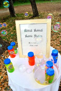 there are many bubbles in the air near a table with a sign on it that says bubble station