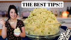 a woman holding a spoon in front of a bowl of mashed potatoes