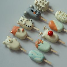 there are many different kinds of cake pops on the stick with animals and seashells