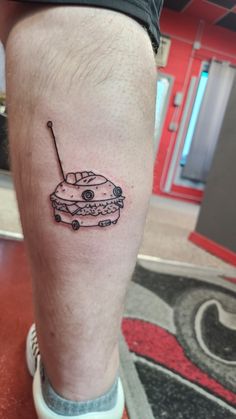 a man's leg with a small tattoo of a car on top of it